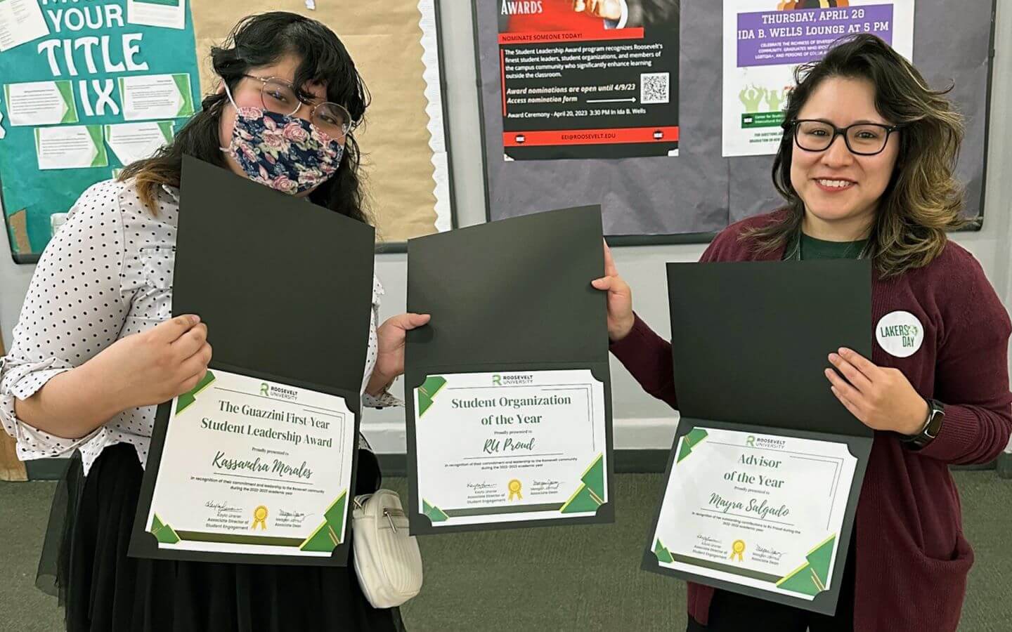 Advisor, Mayra Salgado and student hold award certificates from RU Proud organization.