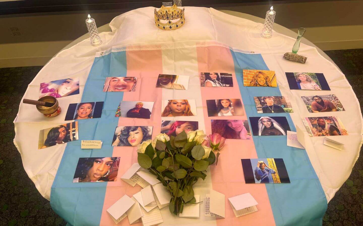 Display of photos, letters, notes, poems, flowers and candles that represent a vigil honoring people who's lives were lost to anti-transgender violence.