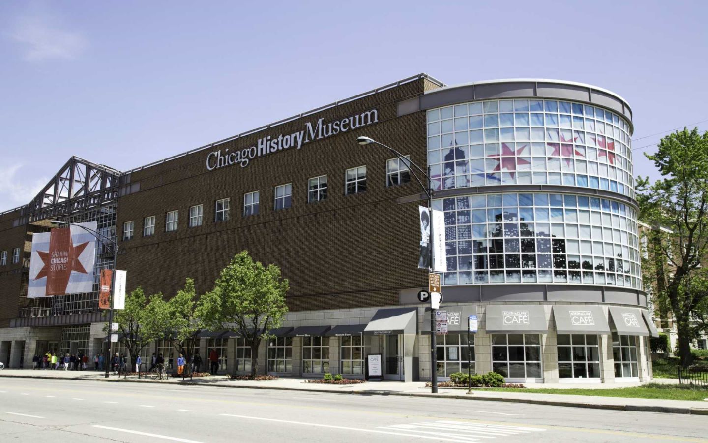 Museum brick building with two stories of bay windows featuring the Chicago city flag.