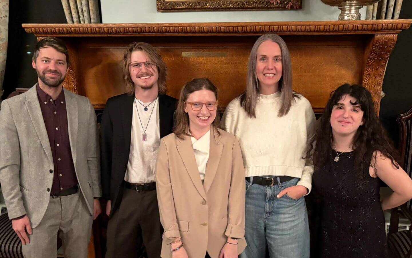 Ryan Amare and Emelia Shankman standing in a group with other authors in the Chicago campus's Sullivan Room