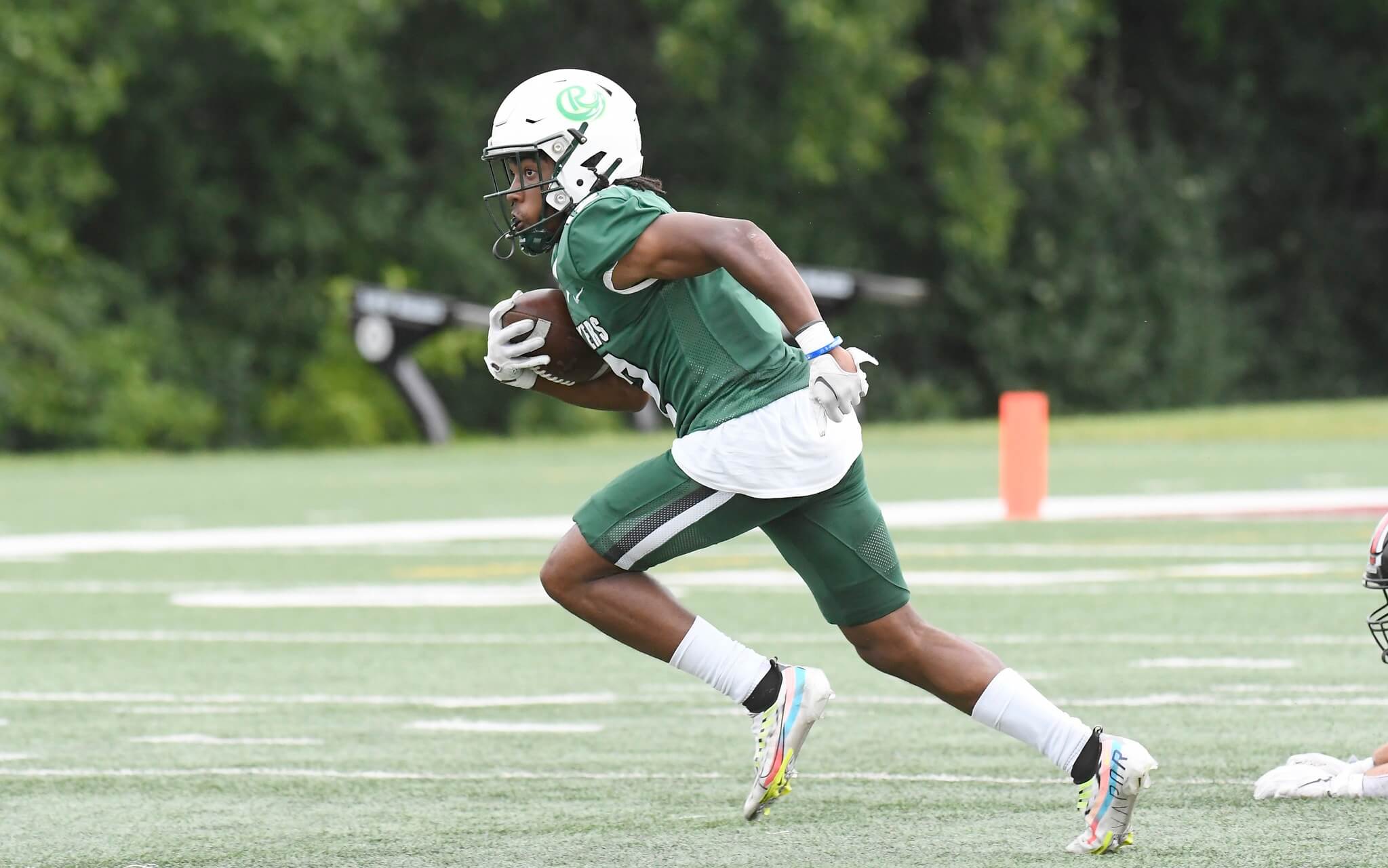 Football player running with the ball on the field