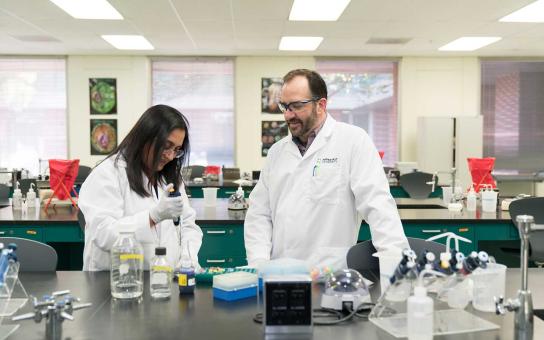 Student and faculty work in a science lab