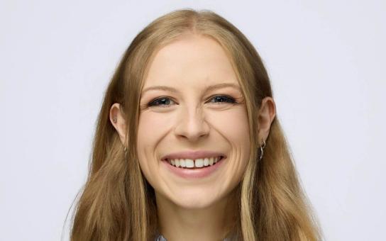 Headshot photo of a smiling Erica “Rickie” Richter on white background.