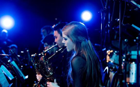 Girl playing saxophone in jazz ensemble